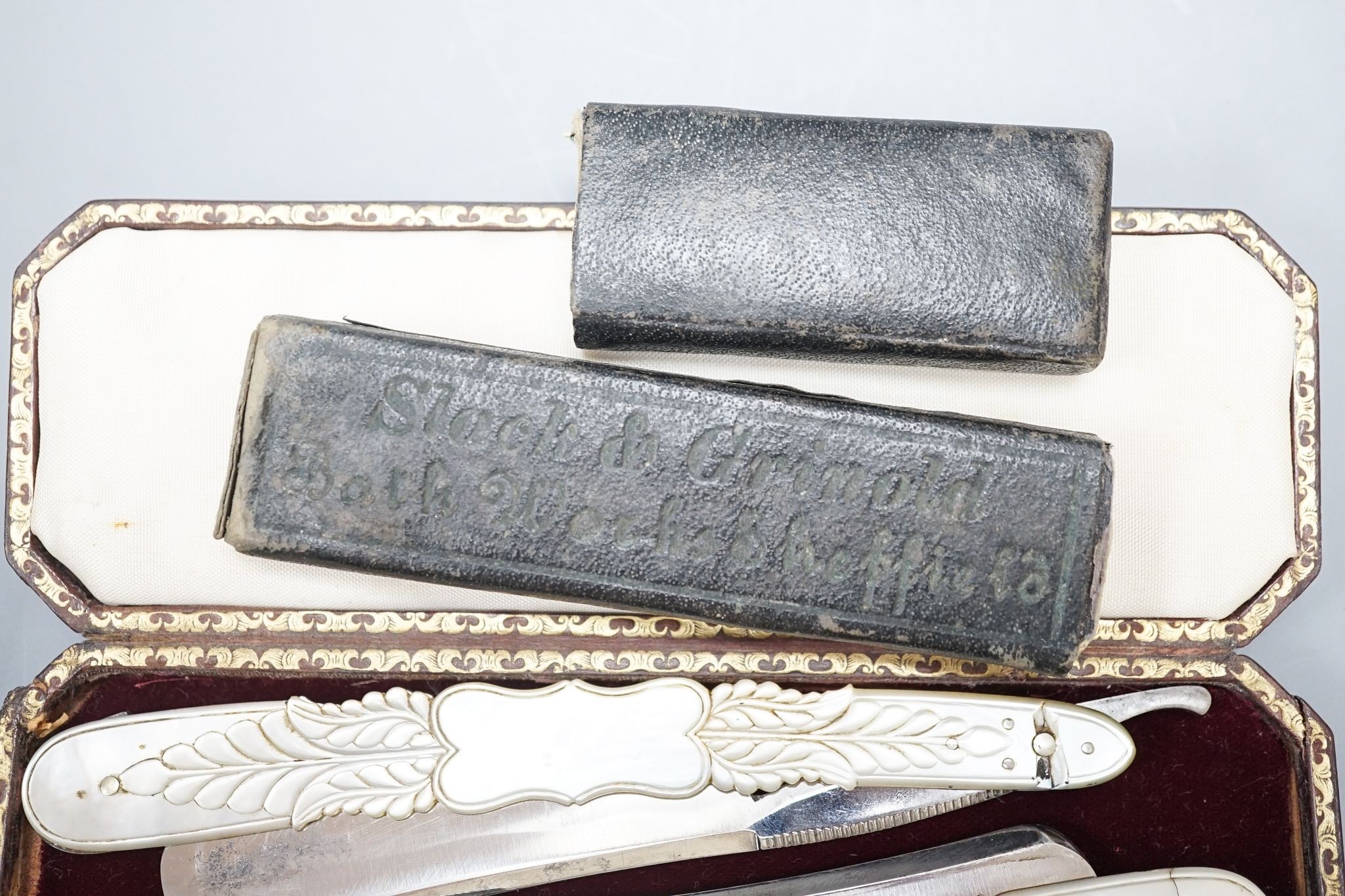 A leather cased pair of mother-of-pearl handled cut throat razors, by J Crawford and three other cased cut throat razors (4)